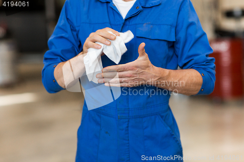 Image of mechanic man or smith with wipe at car workshop