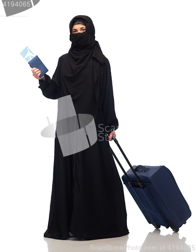 Image of muslim woman with ticket, passport and travel bag