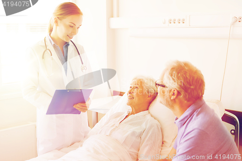 Image of senior woman and doctor with clipboard at hospital