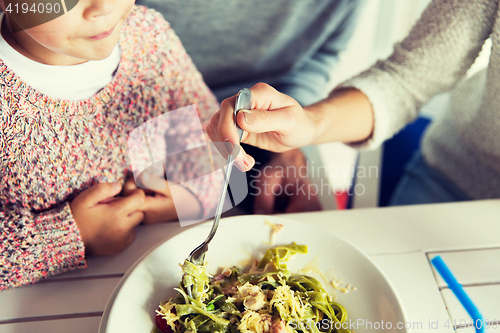Image of close up of family having dinner at restaurant