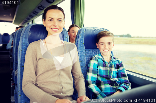 Image of happy family riding in travel bus