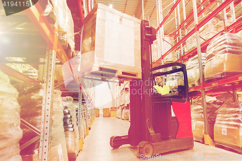 Image of man on forklift loading cargo at warehouse