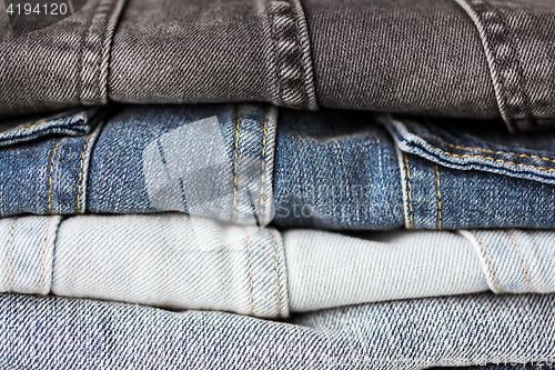 Image of close up of denim clothes or jeans pile