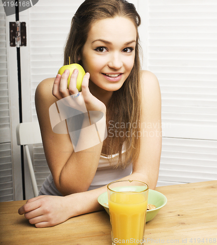 Image of portrait of happy cute girl with breakfast, green apple and orange juice