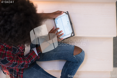 Image of black woman using her electronic tablet