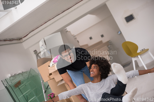 Image of African American couple  playing with packing material