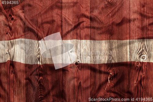 Image of National flag of Latvia, wooden background