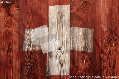 Image of National flag of Switzerland, wooden background