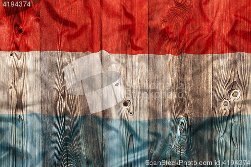 Image of National flag of Luxembourg, wooden background