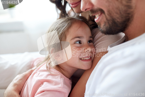 Image of close up of happy family in bed at home