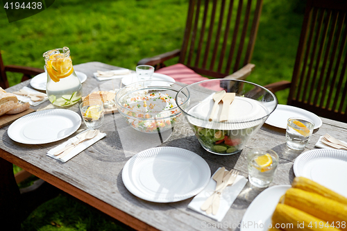 Image of table with food for dinner at summer garden party