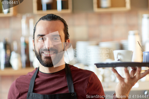 Image of happy man or waiter with coffee and sugar at bar