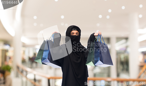 Image of muslim woman in hijab with shopping bags