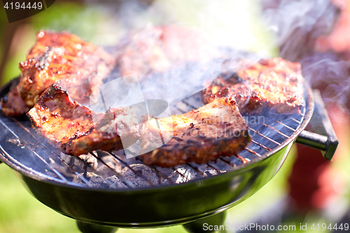 Image of meat cooking on barbecue grill at summer party