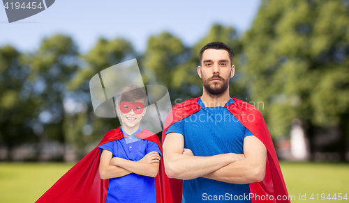 Image of man and boy wearing mask and red superhero cape