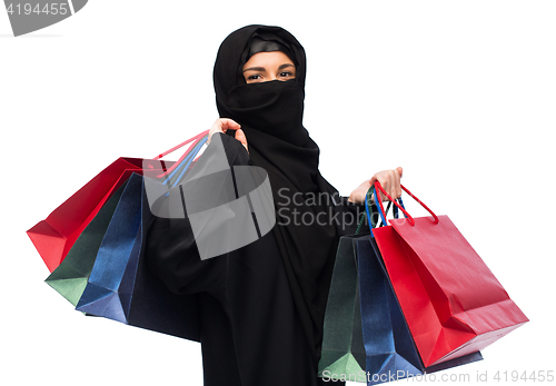 Image of muslim woman in hijab with shopping bags