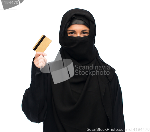 Image of muslim woman in hijab with credit card over white