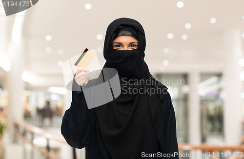 Image of muslim woman in hijab with credit card over white