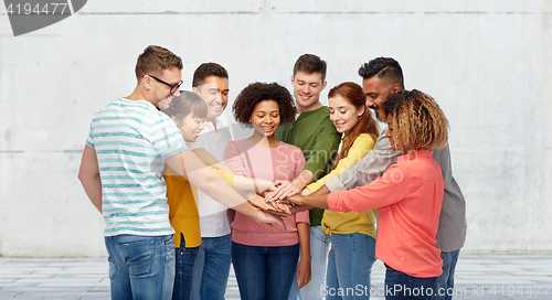 Image of international group of happy people holding hands