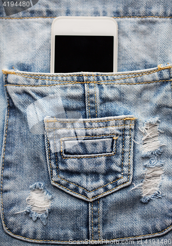 Image of smartphone in pocket of denim overalls