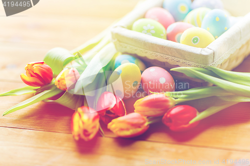 Image of close up of colored easter eggs and flowers