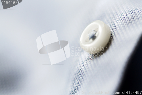 Image of close up of blue shirt button