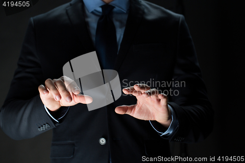 Image of close up of businessman touching virtual screen