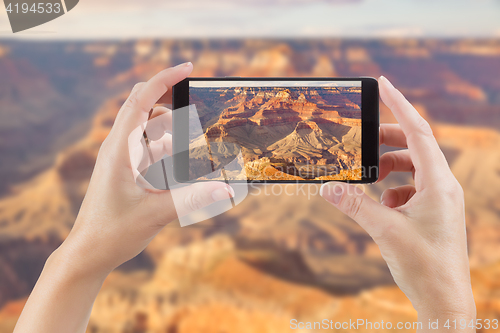 Image of Female Hands Holding Smart Phone Displaying Photo of The Grand C