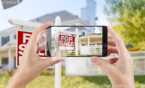 Image of Female Hands Holding Smart Phone Displaying Photo of For Sale Re