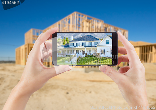 Image of Female Hands Holding Smart Phone Displaying Photo of House with 