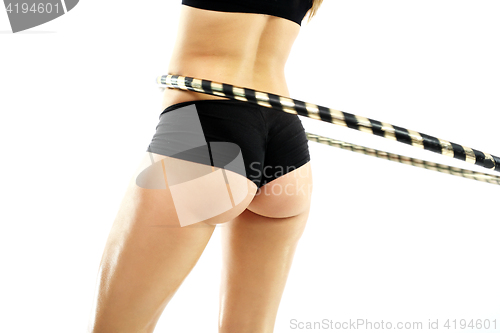 Image of A flat stomach and firm buttocks, the woman trains with wheel Hula Hop.