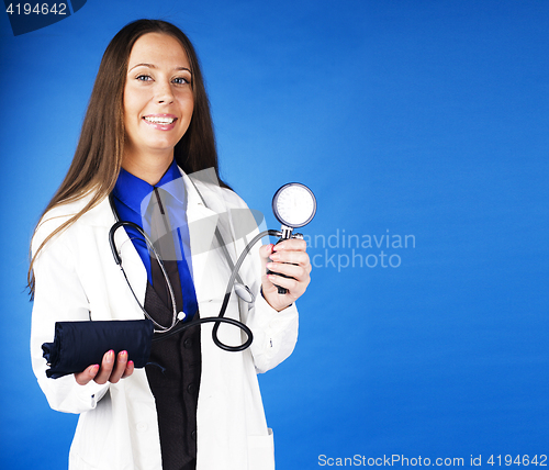 Image of young pretty woman doctor with stethoscope emotional posing, pointing in camers, lifestyle people concept 