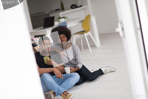 Image of African American couple relaxing in new house