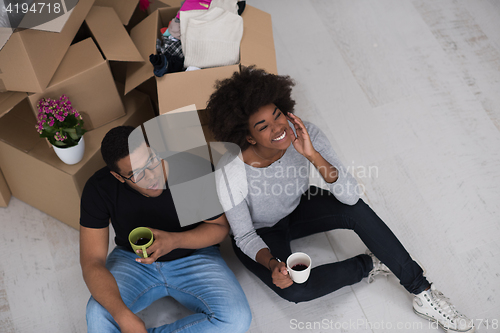 Image of African American couple relaxing in new house