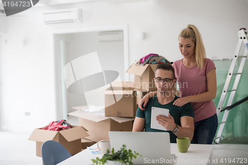 Image of Young couple moving in a new home