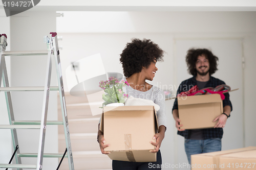 Image of multiethnic couple moving into a new home