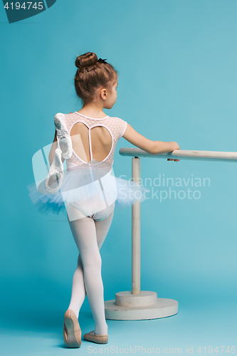Image of The little balerina dancer on blue background