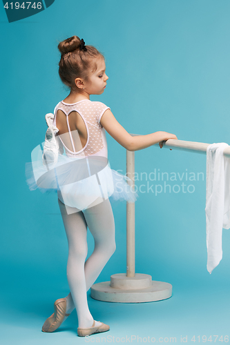 Image of The little balerina dancer on blue background