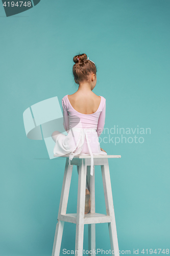 Image of The little balerina dancer on blue background