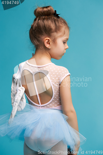 Image of The little balerina dancer on blue background