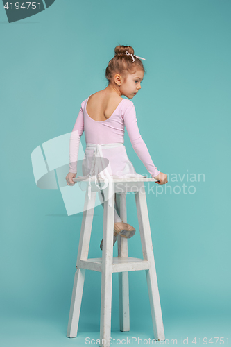 Image of The little balerina dancer on blue background