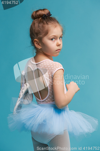 Image of The little balerina dancer on blue background