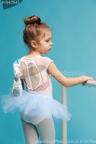 Image of The little balerina dancer on blue background