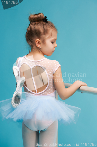 Image of The little balerina dancer on blue background