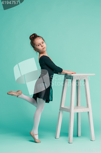 Image of The little balerina dancer on blue background