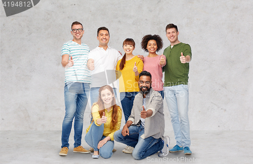 Image of international group of people showing thumbs up