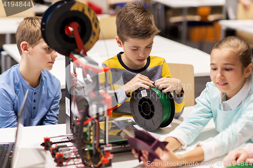 Image of happy children with 3d printer at robotics school