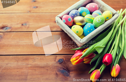 Image of close up of colored easter eggs and flowers