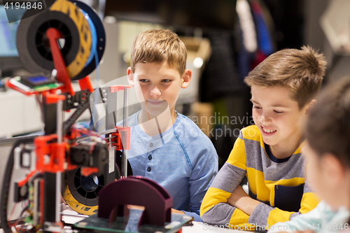 Image of happy children with 3d printer at robotics school