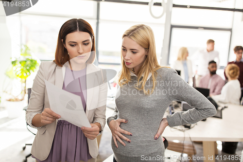 Image of business team with papers in office